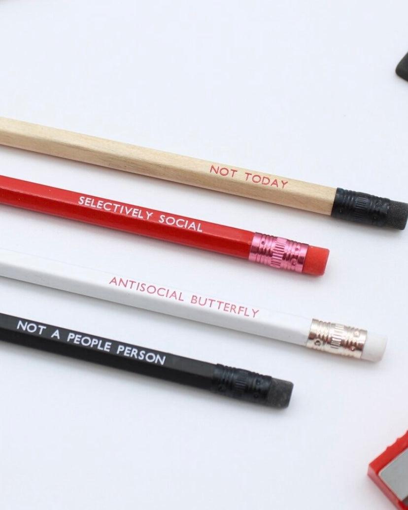 Four pencils with humorous ‘antisocial’ text on a white background