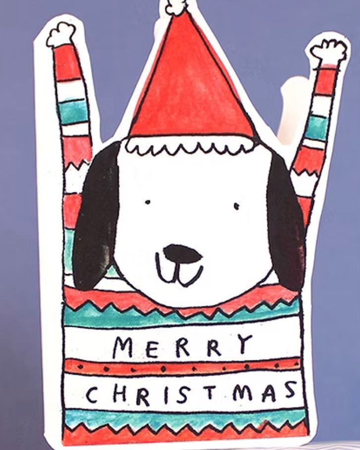 Shaped card of a cartoon dog wearing a Christmas jumper with the text Merry Christmas, on a purple background.