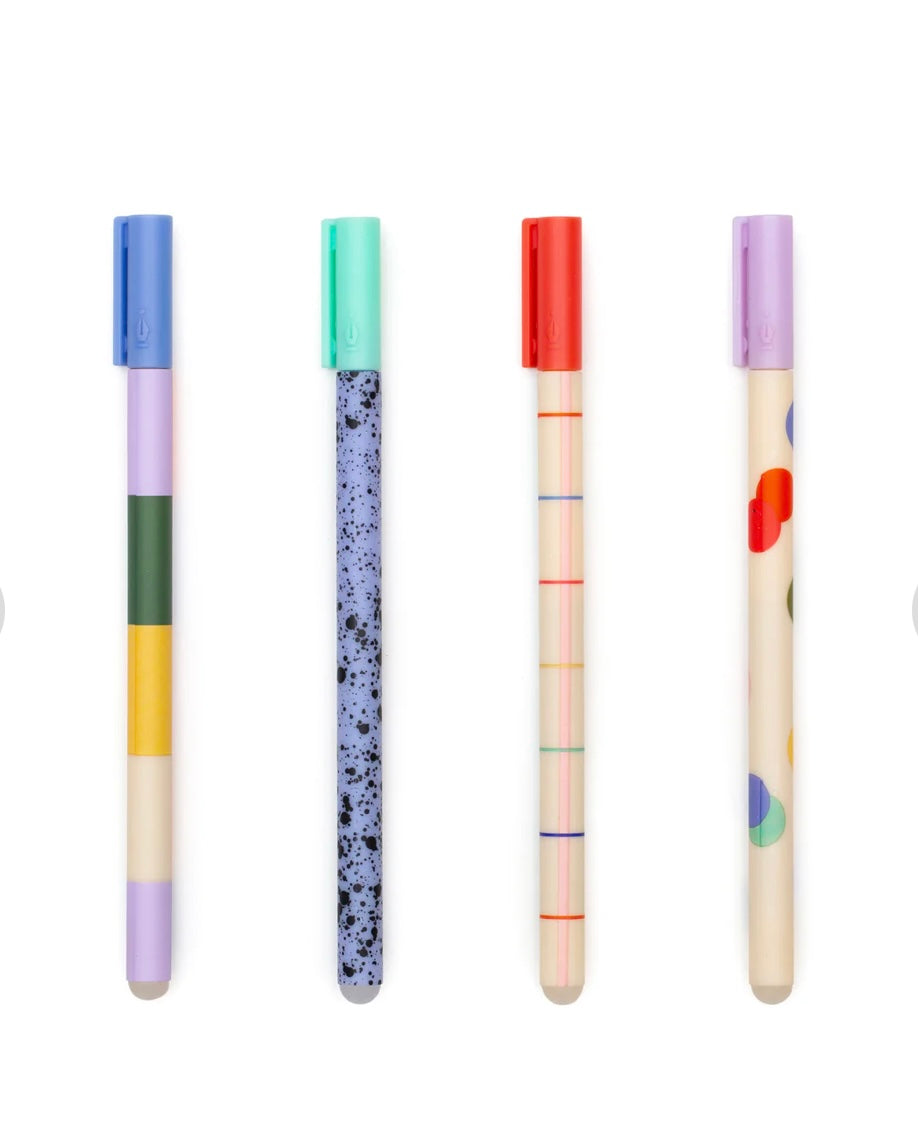 Set of four colourful pens with lids on a white background