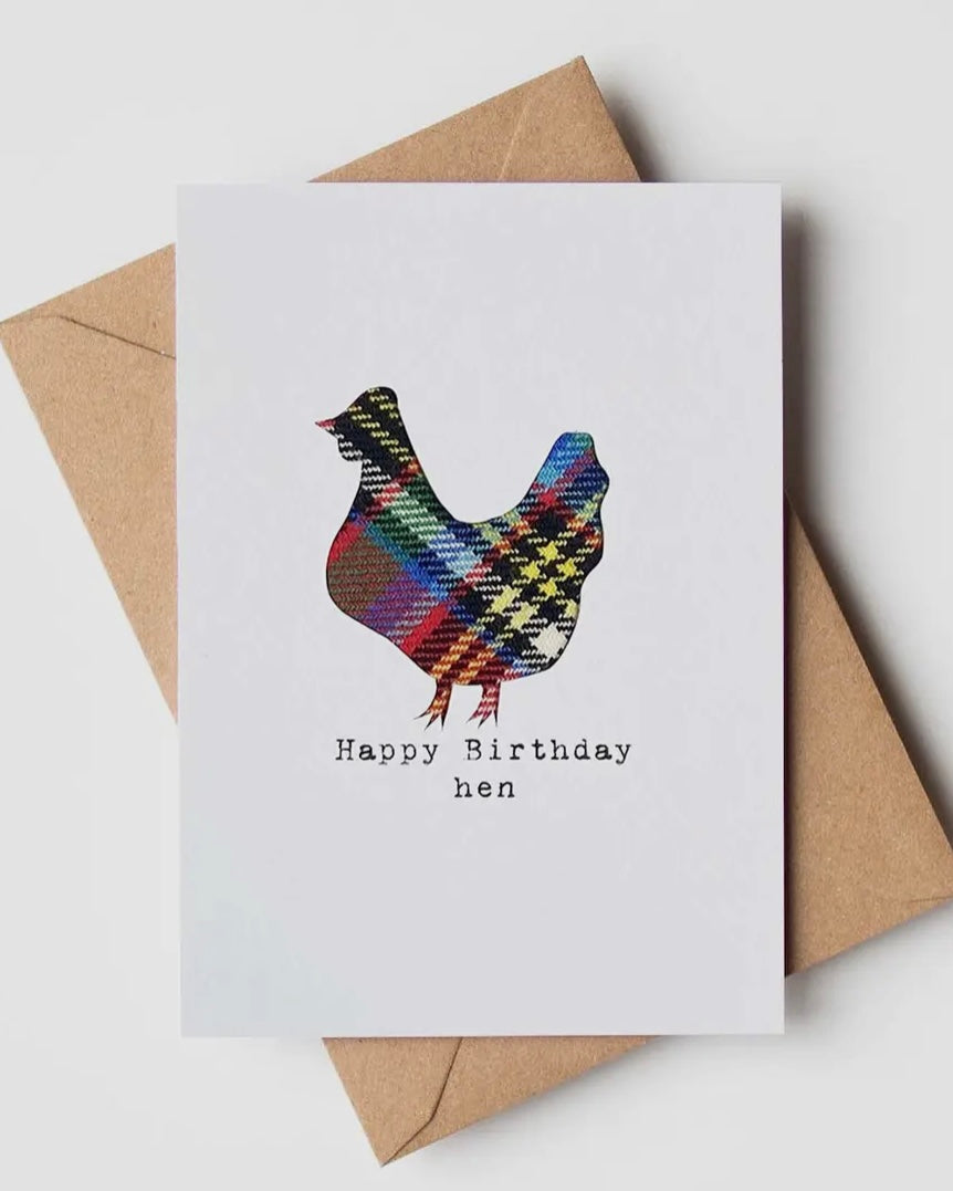 Greeting card with a real cloth tartan hen design and 'Happy Birthday Hen' text, placed on a white surface with a brown envelope.