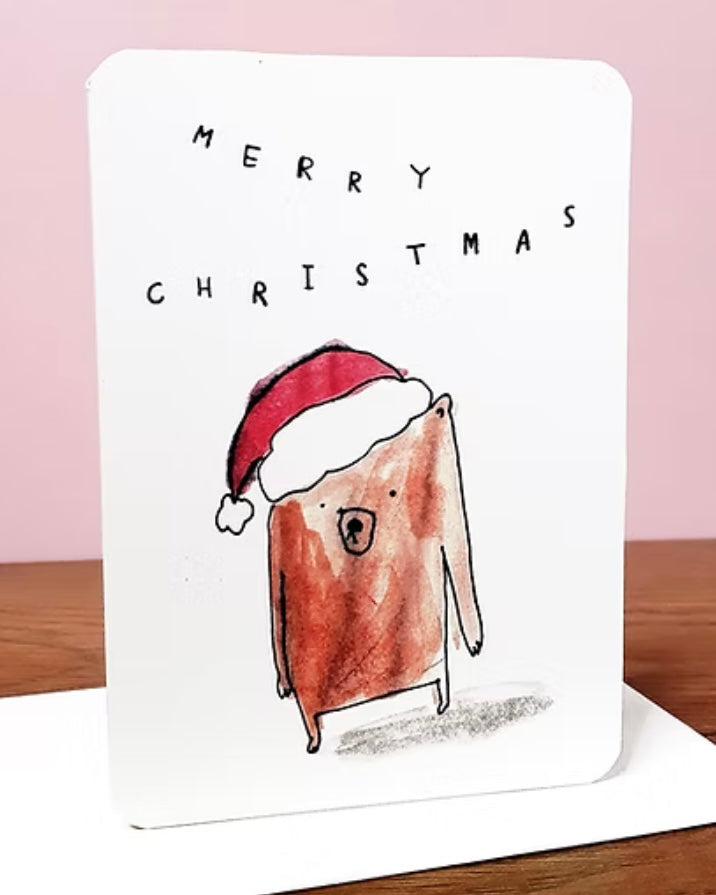 Christmas card with a cartoon bear wearing a Santa hat and 'Merry Christmas' text, with a white envelope.