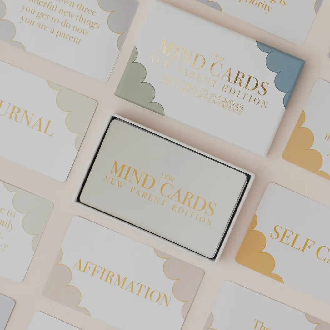 Set of 'Mind Cards: New Parent Edition' with gold text on a light background