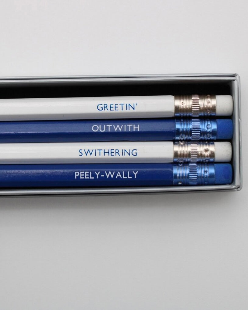 Set of four pencils with uniquely Scottish words printed on them, displayed in a box.