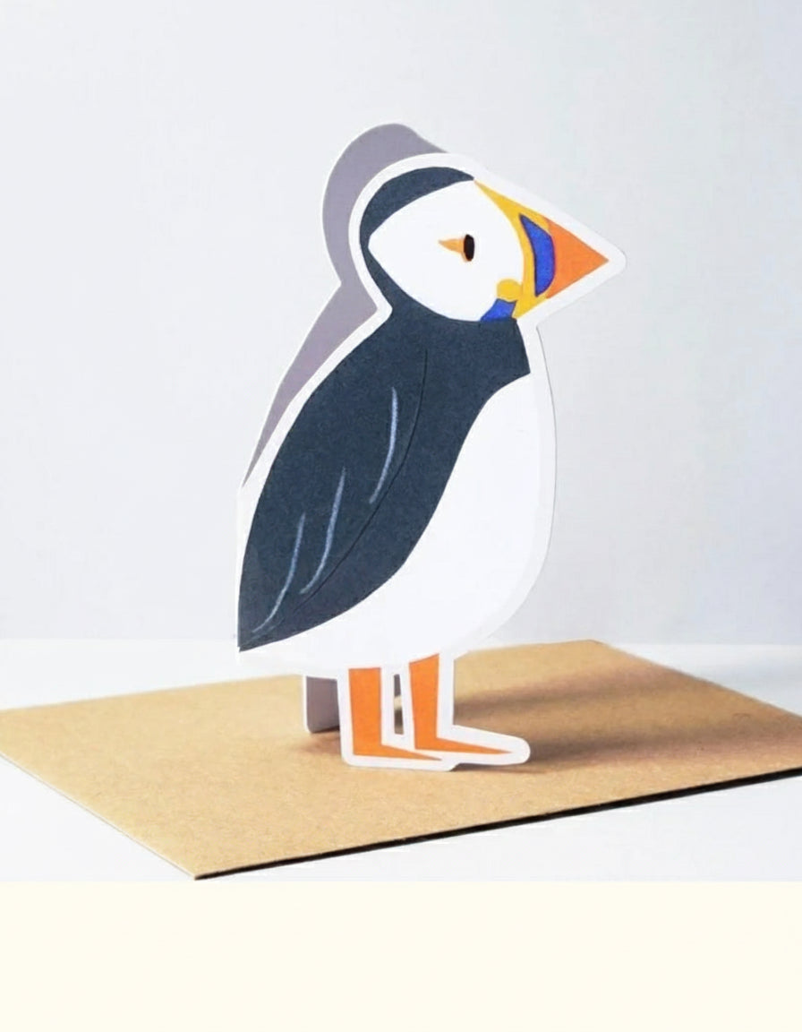 3D paper craft card of a puffin on a white background