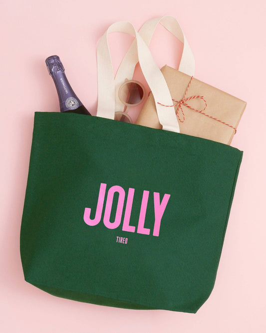 Green tote bag with 'Jolly' text on a pink background