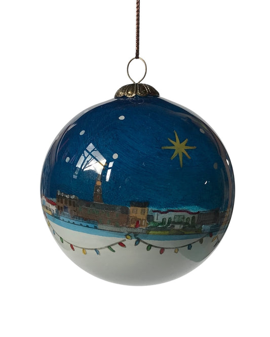 Handpainted glass bauble with a night-time Stonehaven skyline, featuring a star and buildings, with a string for hanging.