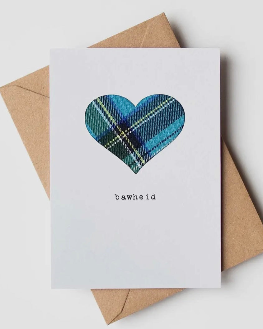 White card with a real tartan cloth heart inset and the word Bawheid, with a brown kraft envelope  