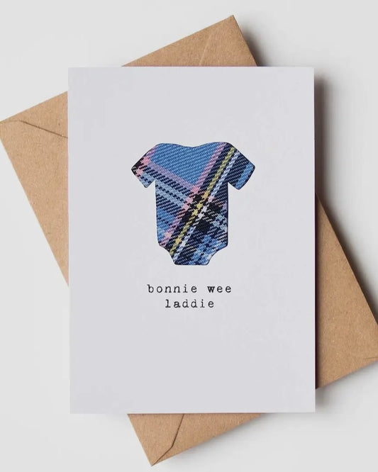 White card with blue tartan cloth insert with the words Bonnie wee laddie, on a brown kraft envelope