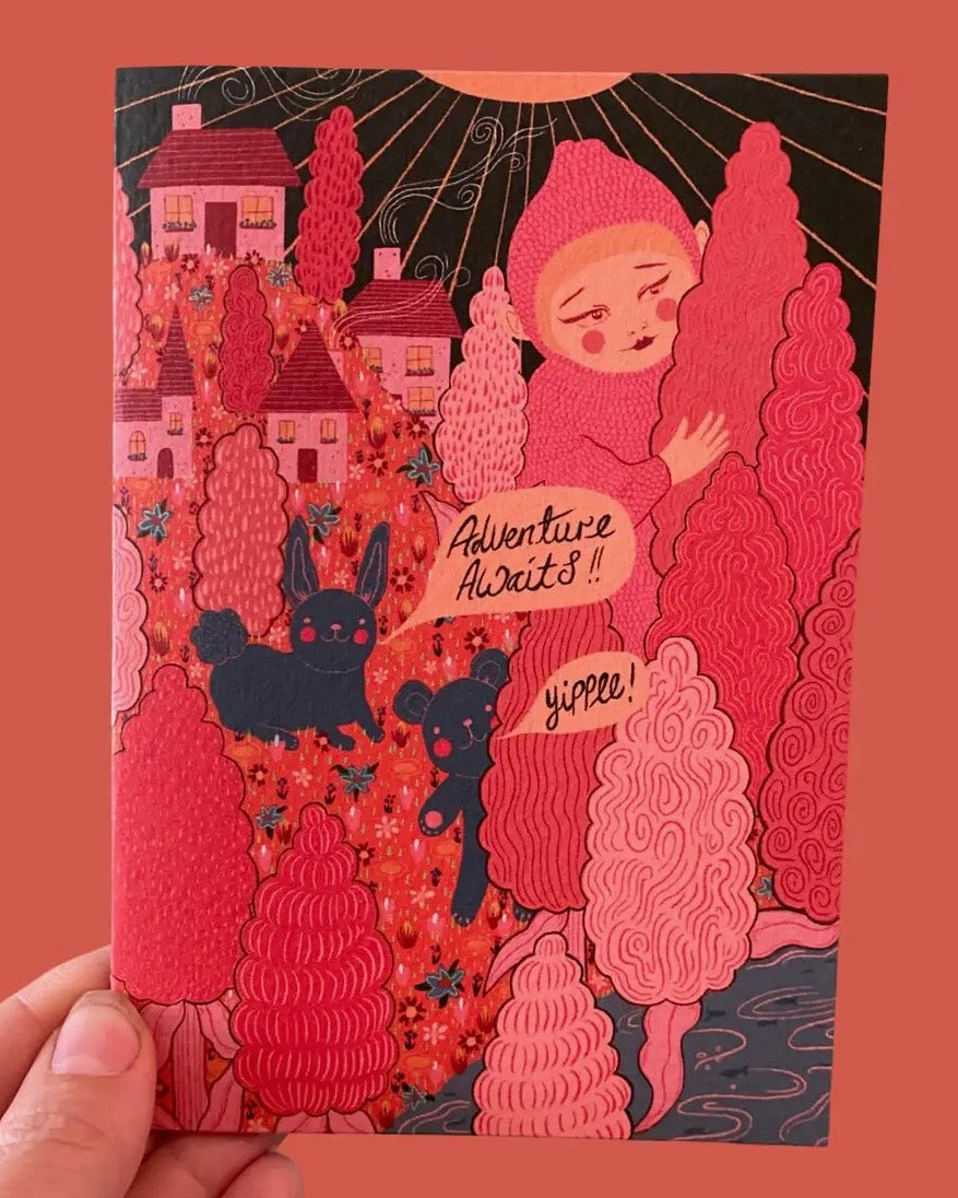 Illustrated greeting card with a girl, dog, and castle on a red background with the words Adventure Awaits. 