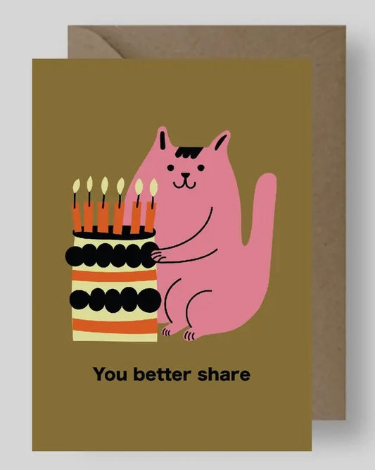 Greeting card with a pink cat holding a birthday cake and candles with the words ‘You better share’ on a brown background
