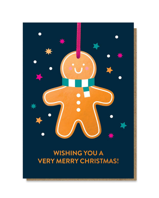 Greeting card with a gingerbread man design and festive text on a dark blue background.