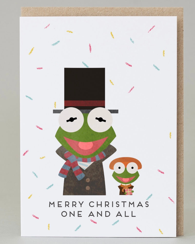 Christmas card with Muppet Kermit the frog wearing a top hat and scarf, surrounded by coluorful confetti and the words 'Merry Christmas One And All'