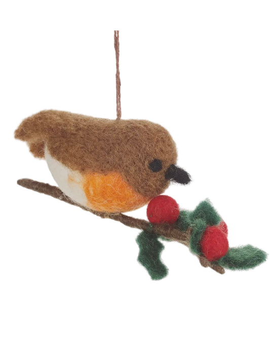 Felt robin bird ornament on a branch with berries on a white background