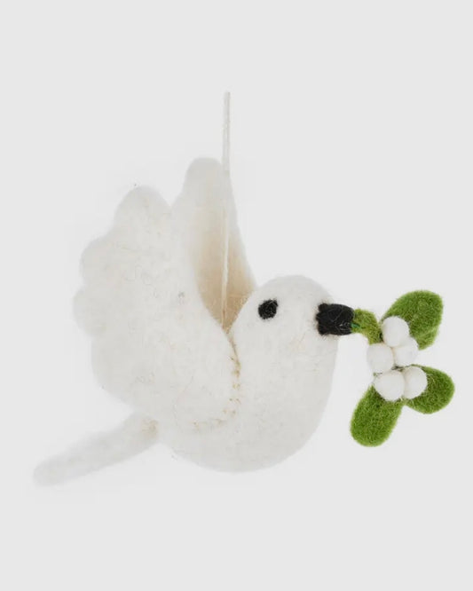 White plush felt dove holding a green leaf with white flowers on a light gray background