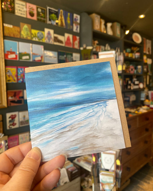 Small greetings card featuring a beach scene.