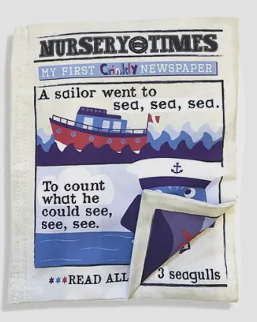 Children's soft crinkly newspaper with a sailboat illustration and text on a white background