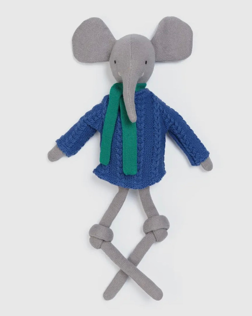 Toy elephant with a blue sweater and green scarf on a white background