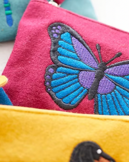 A product listing screenshot for a 'Felt Butterfly Purse' by Just Trade