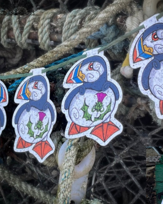 Decorative garland of puffins displayed on a fishing net