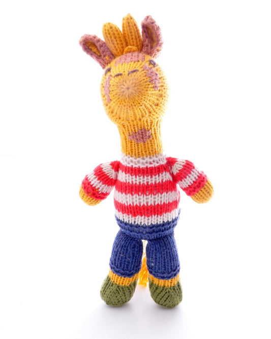 Knitted giraffe toy with a striped sweater on a white background