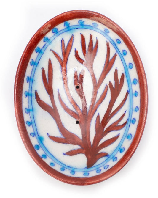 Ceramic soap dish with pinky brown coral design on a white background