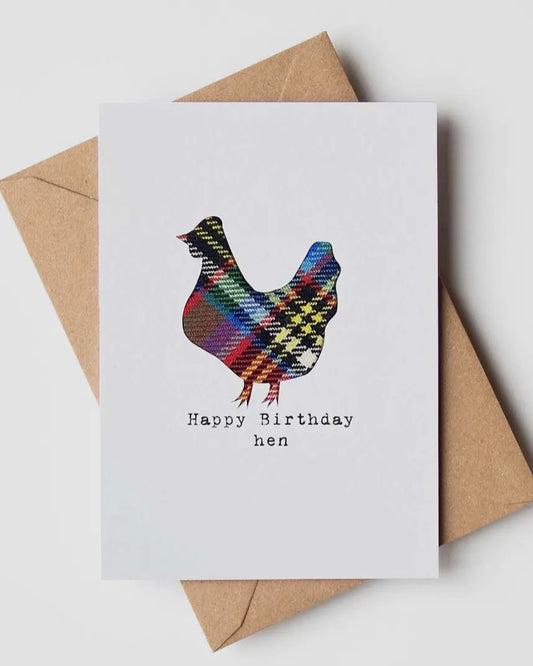Greeting card with a real cloth tartan hen design and 'Happy Birthday Hen' text, placed on a white surface with a brown envelope.