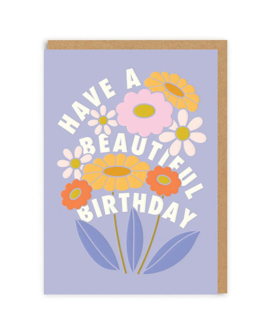 Greeting card with colorful flowers and 'Have a Beautiful Birthday' text on a light purple background.