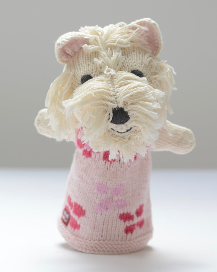 Knitted white Scottie dog hand puppet toy with pink dress, on a white background