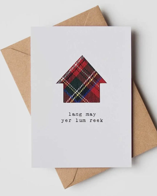 White card with a real tartan cloth house shape inset, and the words Lang May Yer Lum Reek underneath, with a brown envelope
