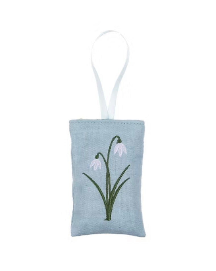 Small rectangular lavender pouch with embroidered snowdrops design on a white background