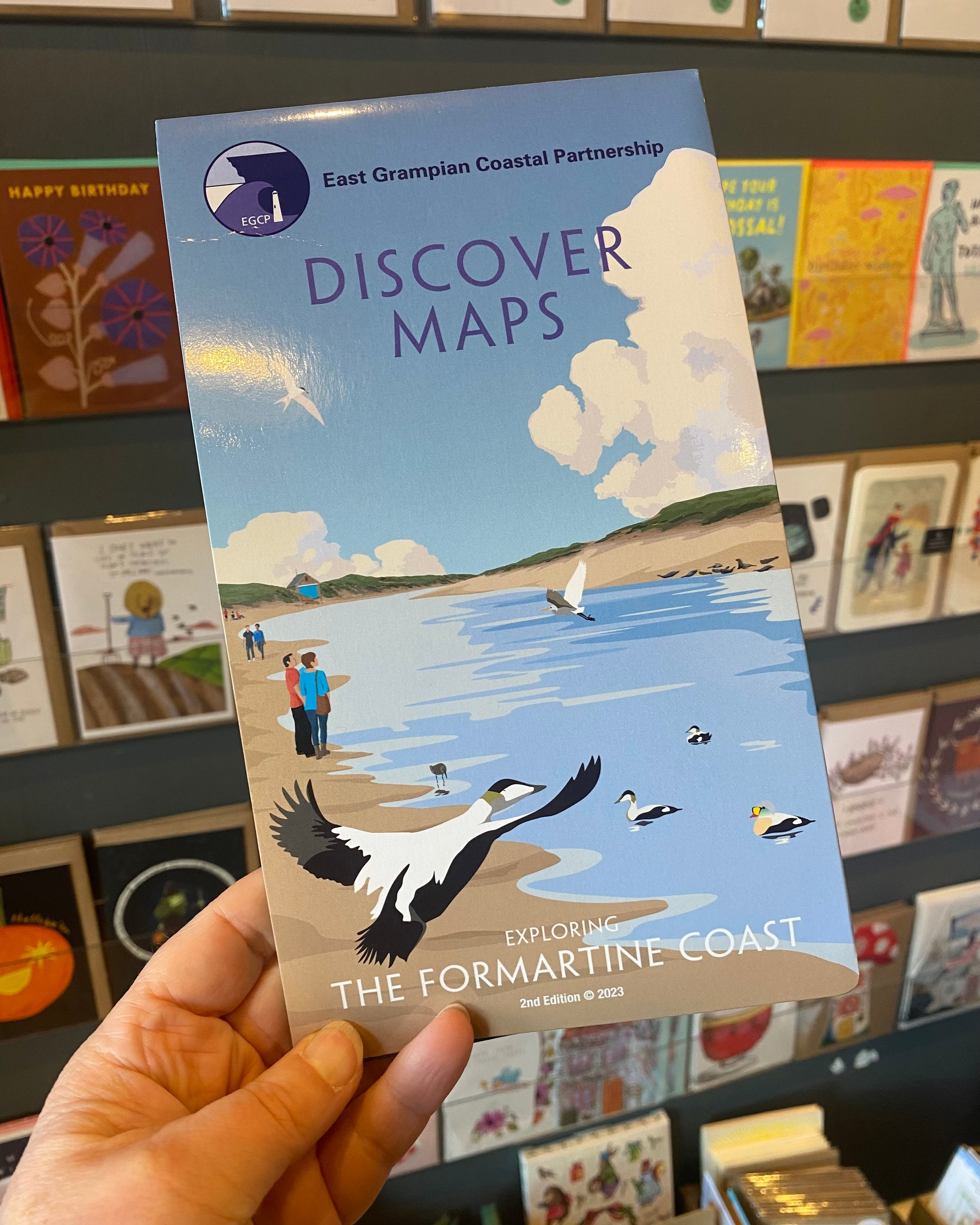 Formartine version of the East Grampian Coast Discover Map held in a store setting