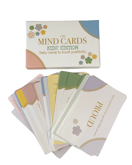 A set of colorful cards fanned out, with the top card reading 'MIND CARDS Kids’ Edition' and each subsequent card displaying different mindfulness exercises or guidance.