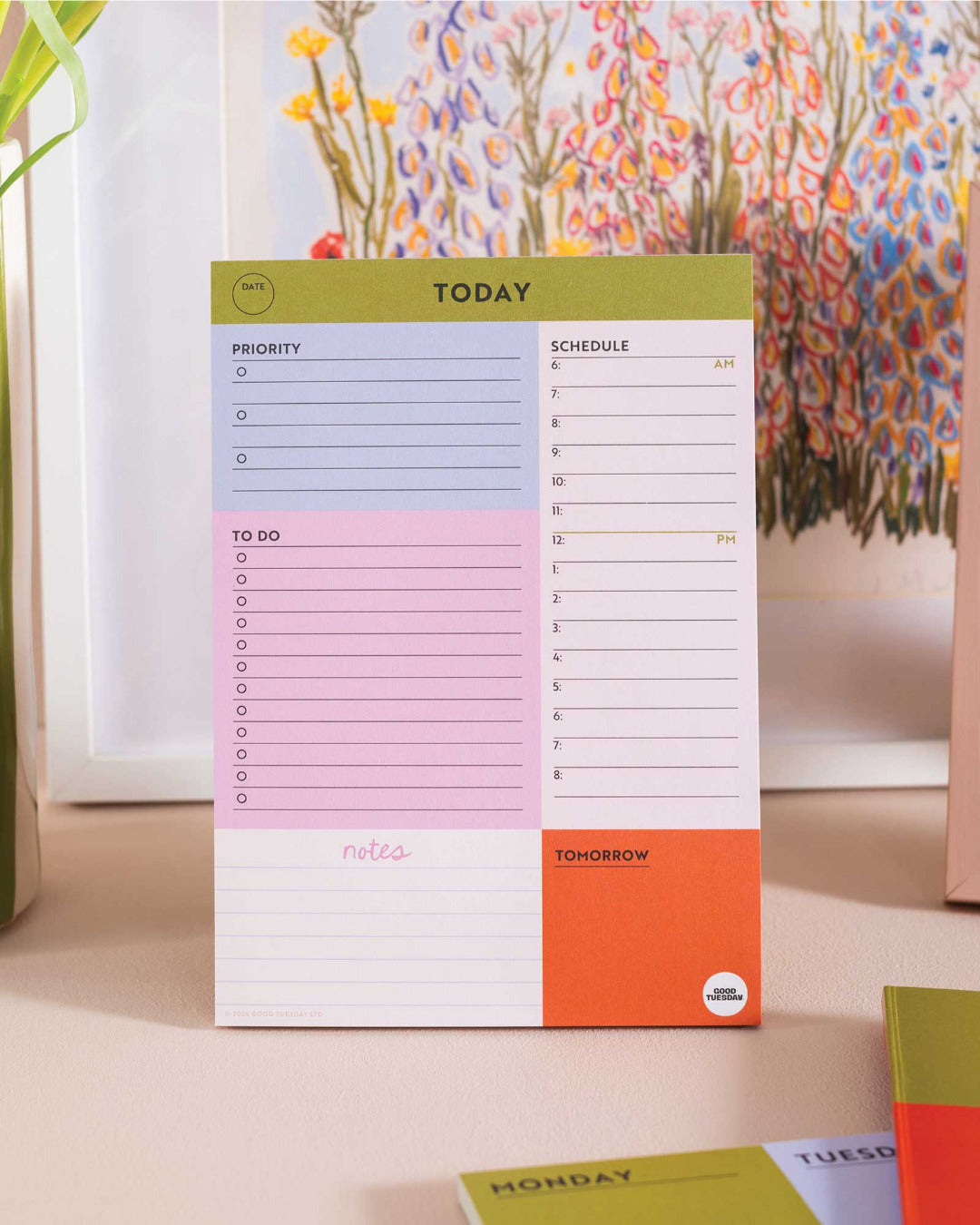 Colourful daily planner on a desk with decorative elements