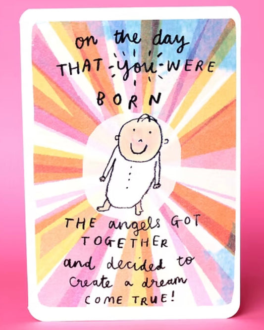 New Baby card with a colourful design and text  beginning ‘On the day that you were born…’ on a pink background