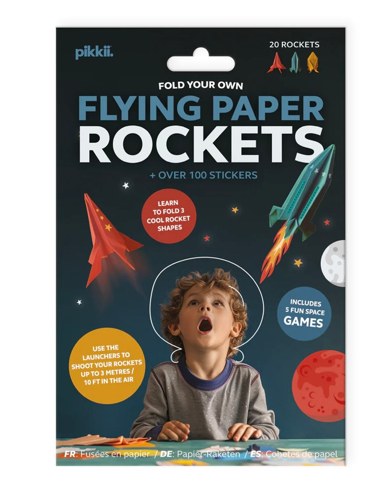 Packaging of Pikkii flying paper rockets with a child and rocket illustrations on a dark blue background.
