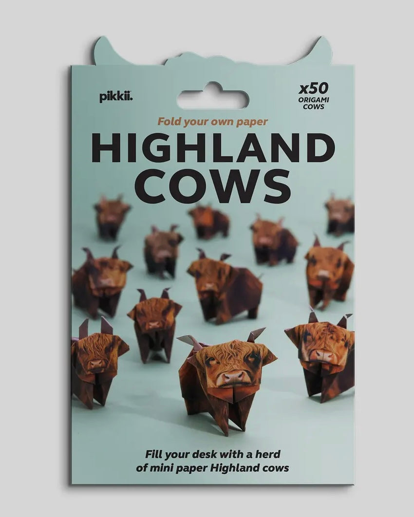 Packaging of pikkii Highland Cow origami kit on a light gray background