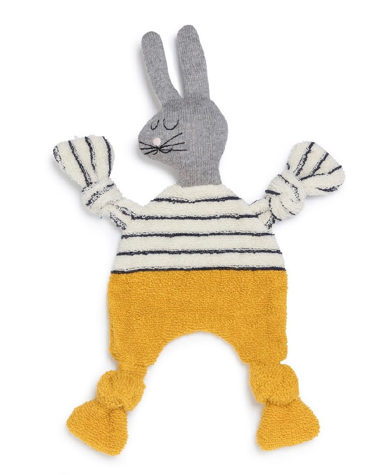 Knitted toy rabbit with a striped sweater and yellow pants on a white background