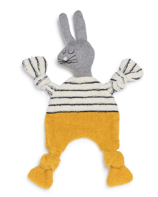 Knitted toy rabbit with a striped sweater and yellow pants on a white background