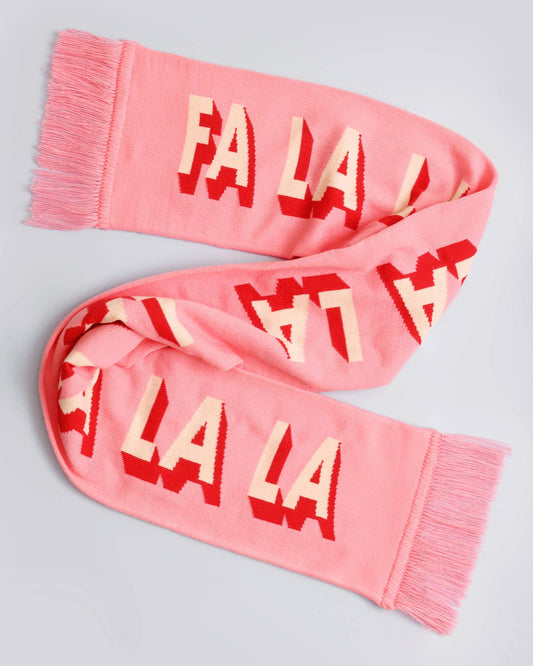 Pink scarf with 'FA LA LA' pattern on a light gray background