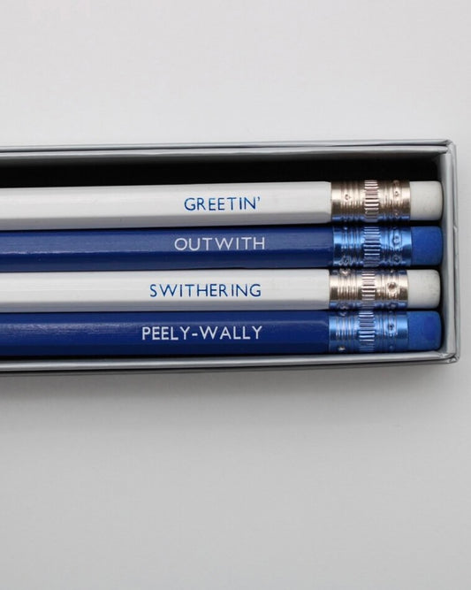 Set of four pencils with uniquely Scottish words printed on them, displayed in a box.