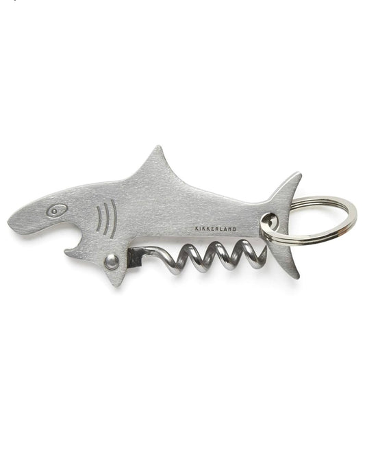 Shark-shaped metal bottle opener keyring with corkscrew on a white background