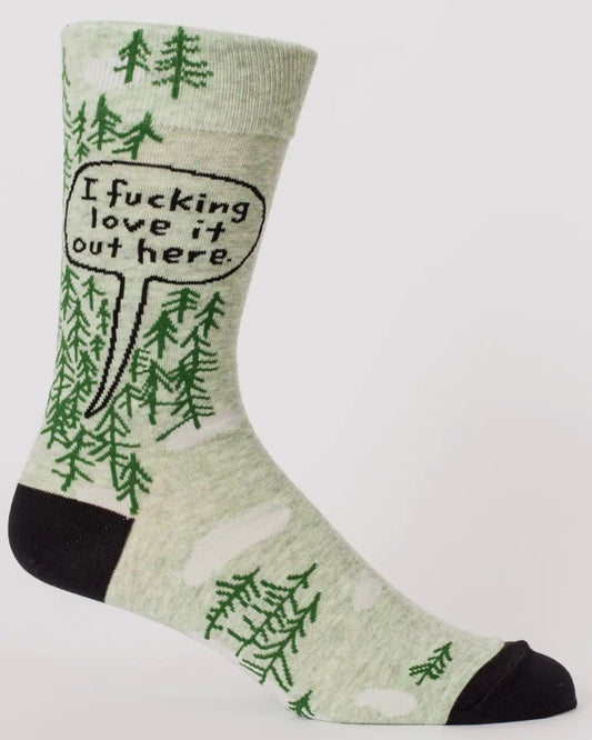 Sock with green tree patterns and text 'I fucking love it out here' on a white background