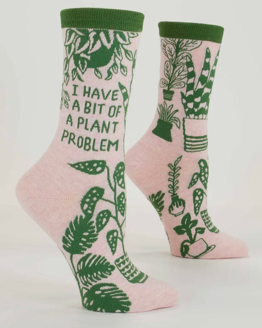 Pink socks with green plant patterns and text on a white background
