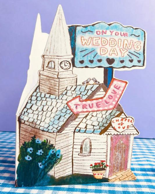 Decorative shaped card with a church illustration with 'On Your Wedding Day' and ‘True Love’ signs. 
